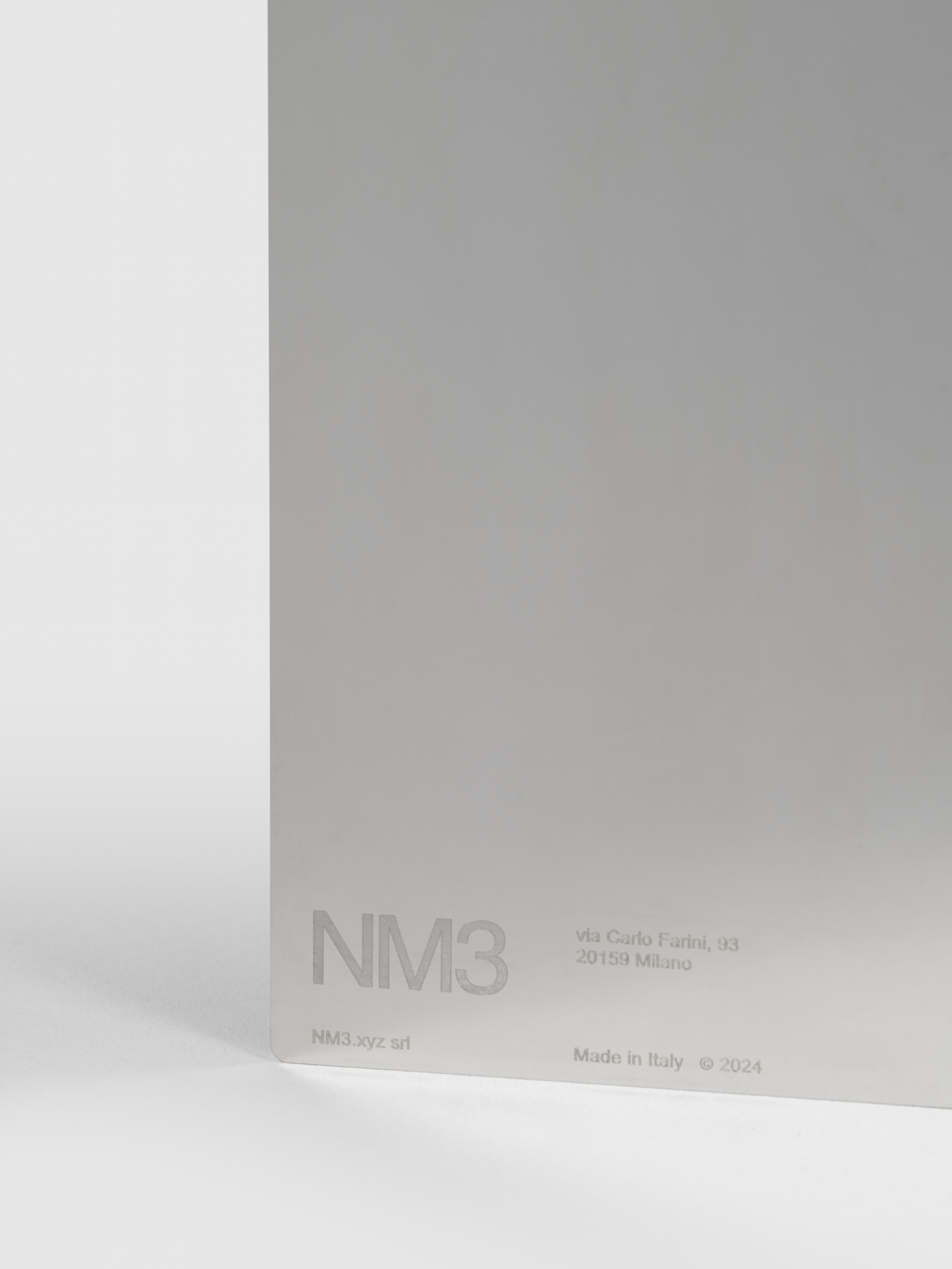 NM05.1: the steel podium defined by clean edges and exposed fasteners